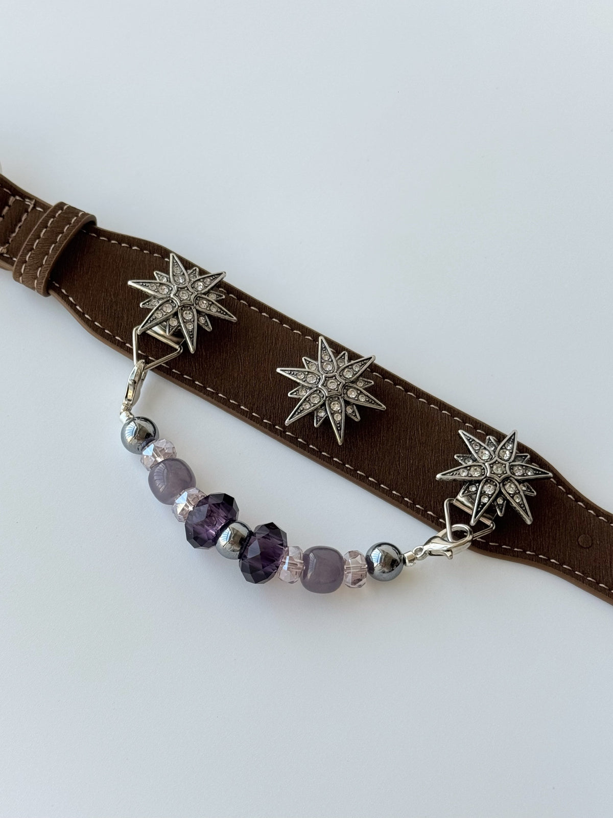 Pawlsle Trails "North Star" jeweled pet collar, crafted from brown microfiber leather and adorned with a rhinestone North Star emblem; features an interchangeable, hand-beaded gemstone chain. Suitable for cats as well as medium-to-large dogs.