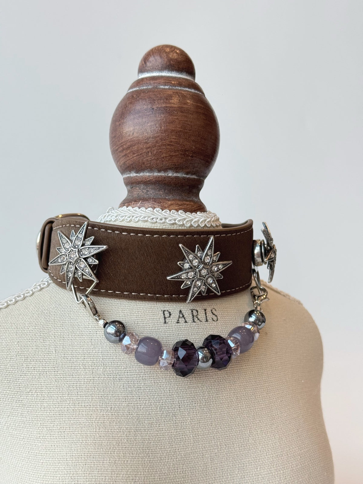 Pawlsle Trails "North Star" jeweled pet collar, crafted from brown microfiber leather and adorned with a rhinestone North Star emblem; features an interchangeable, hand-beaded gemstone chain. Suitable for cats as well as medium-to-large dogs.