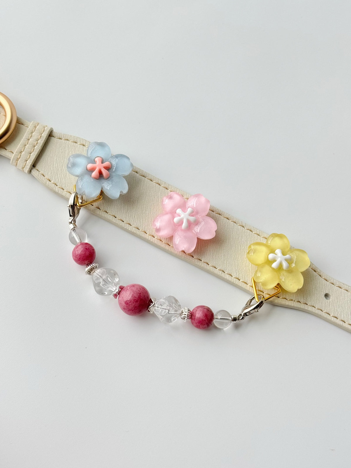 Pawlsle Trails Cherry blossom-themed pet collar set, featuring a beige microfiber leather collar adorned with a detachable, handcrafted chain of beaded gems—a floral-style accessory designed for cats as well as small, medium, and large dogs.