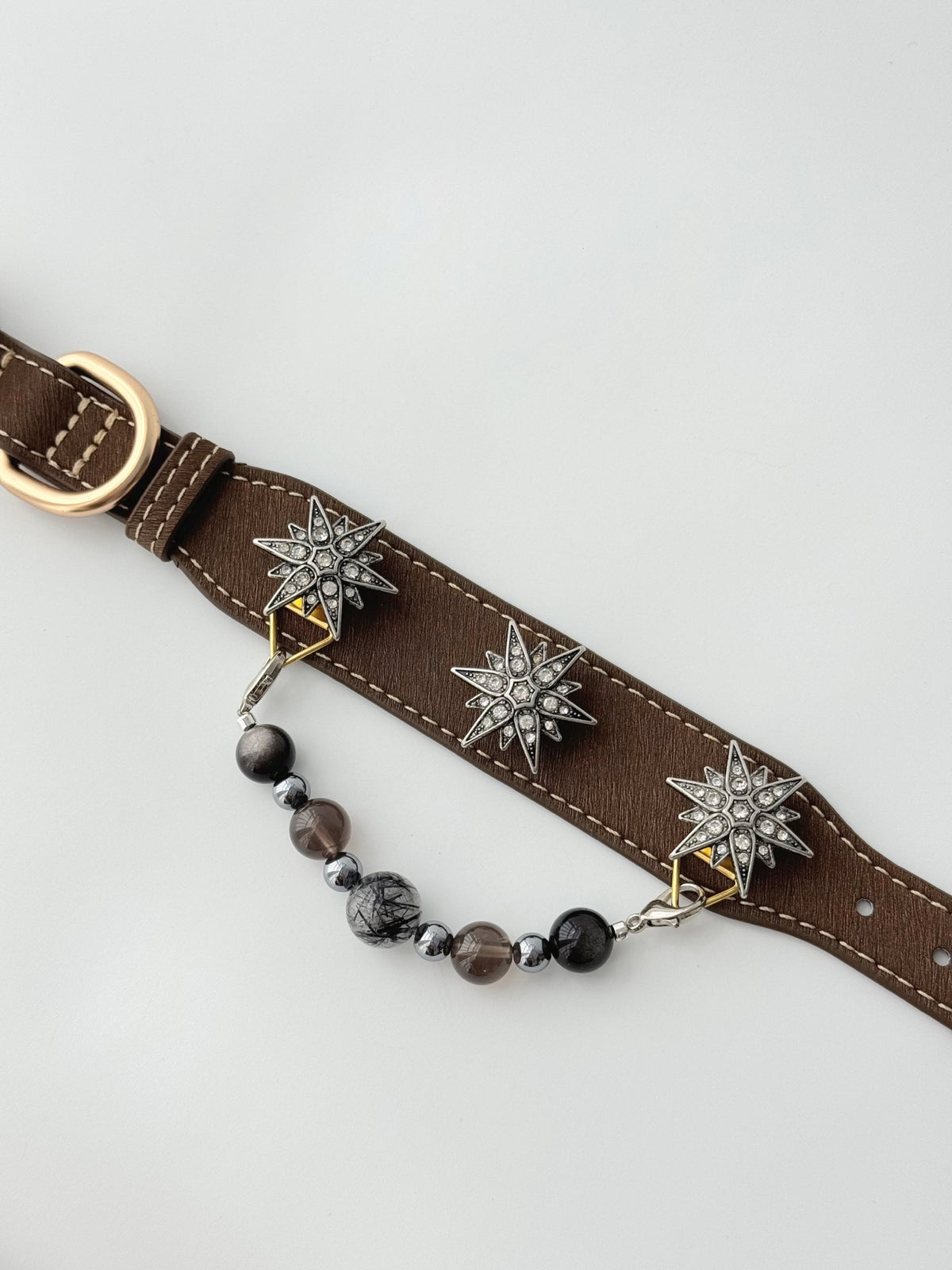 Pawlsle Trails "North Star" jeweled pet collar, crafted from brown microfiber leather and adorned with a rhinestone North Star emblem; features an interchangeable, hand-beaded gemstone chain. Suitable for cats as well as medium-to-large dogs.