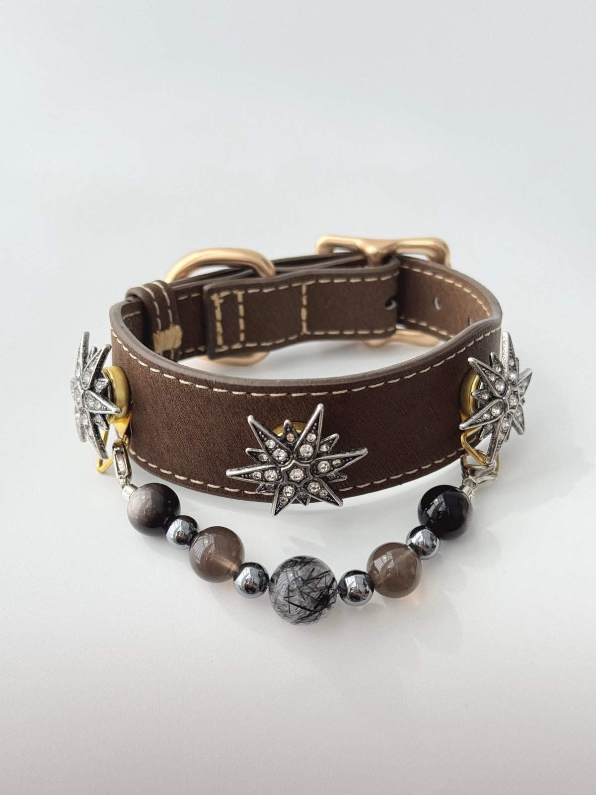 Pawlsle Trails "North Star" jeweled pet collar, crafted from brown microfiber leather and adorned with a rhinestone North Star emblem; features an interchangeable, hand-beaded gemstone chain. Suitable for cats as well as medium-to-large dogs.