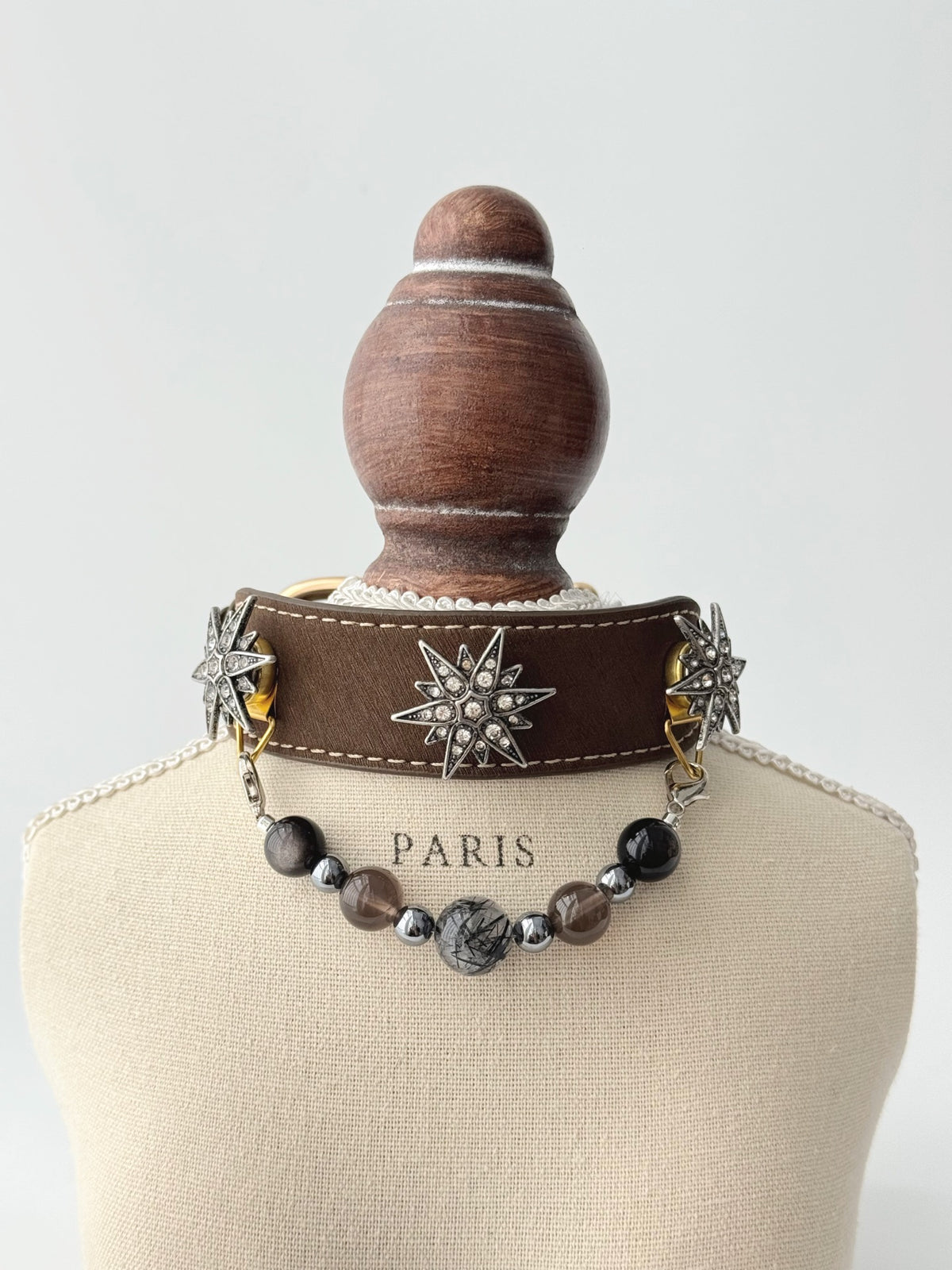 Pawlsle Trails "North Star" jeweled pet collar, crafted from brown microfiber leather and adorned with a rhinestone North Star emblem; features an interchangeable, hand-beaded gemstone chain. Suitable for cats as well as medium-to-large dogs. Style 1
